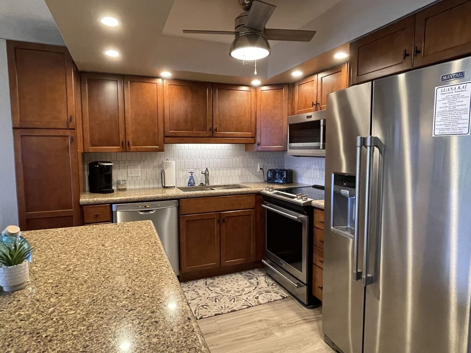 Well equipped updated kitchen with walk around island and granite countertops