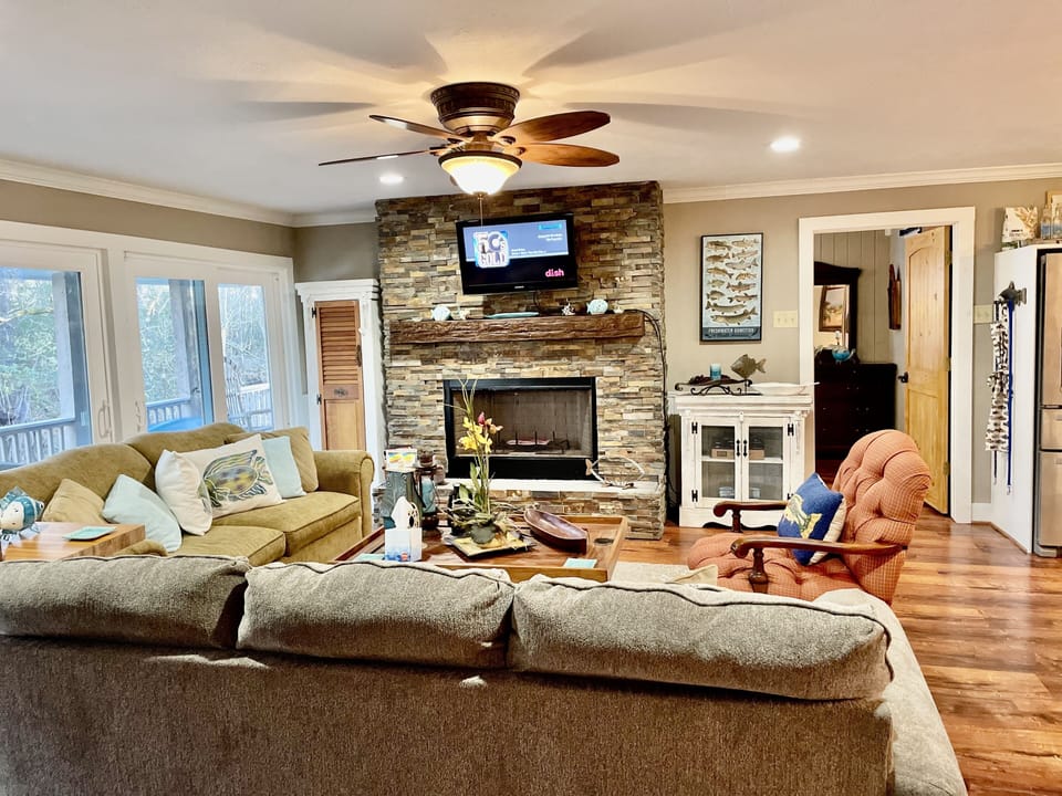 family room entertaining area with stone fireplace
