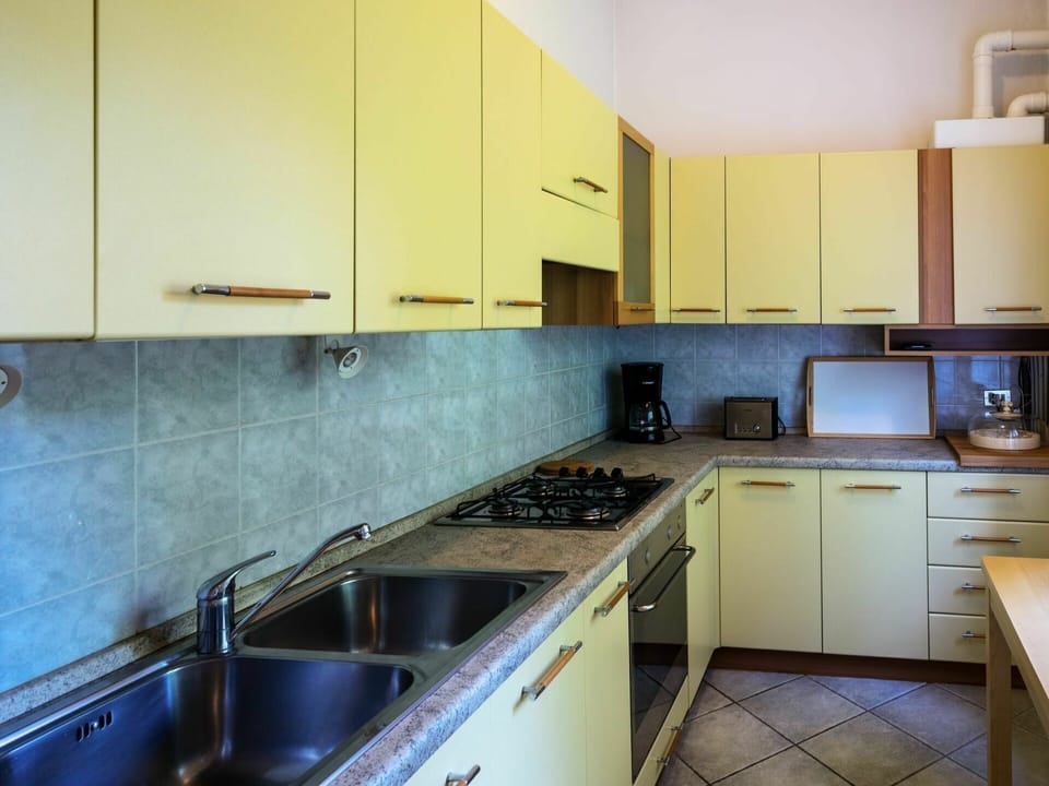 Countertop, Property, Room, Kitchen, Cabinetry, Furniture, Yellow, Building, Interior Design, House