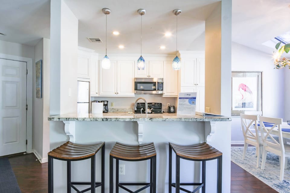 There are three stools at the kitchen counter.
