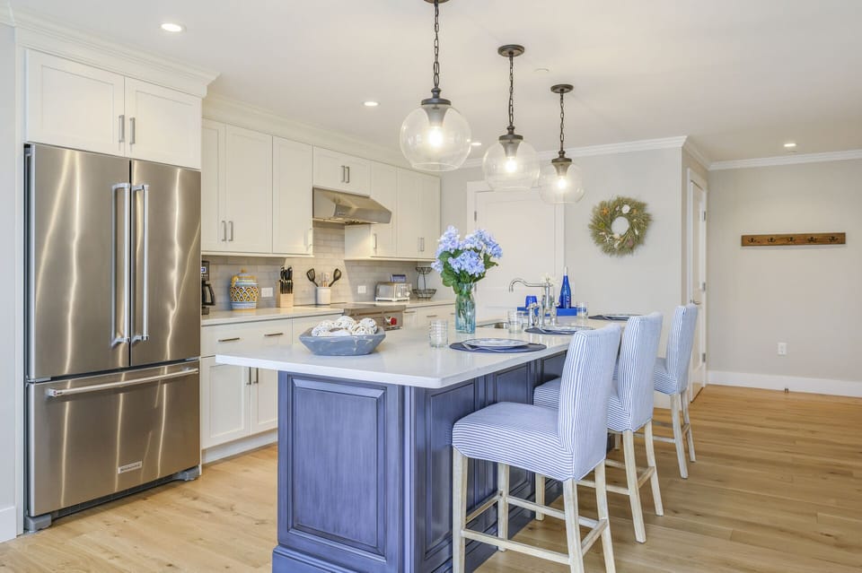 Beautiful Chefs kitchen with seating for 3 at the center island with all stainless appliances