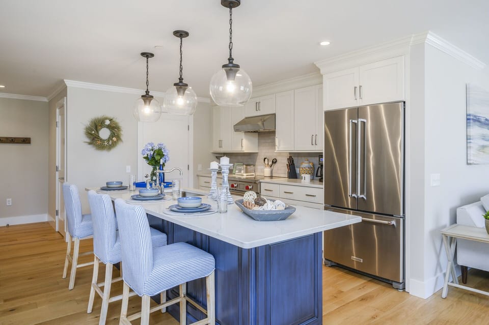 Luxury Kitchen with all high-end stainless appliances, and walk in pantry containing the washer and dryer.