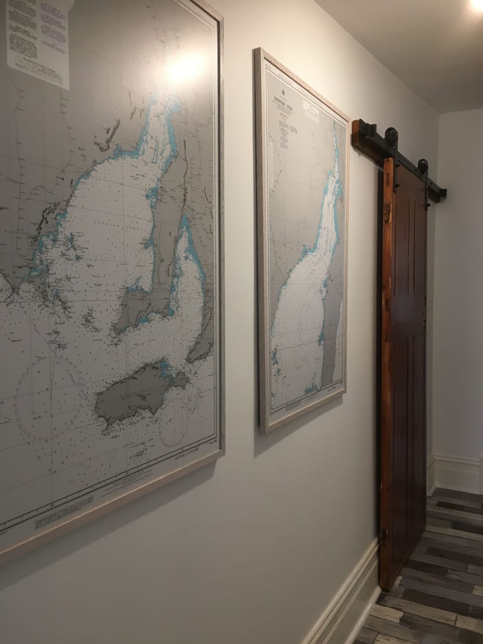 Local sea charts line the hallway