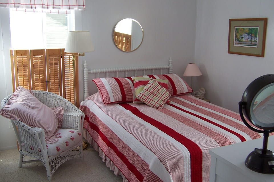 Upstairs Front Bedroom is bright & airy, with a cozy reading spot & full closet.
