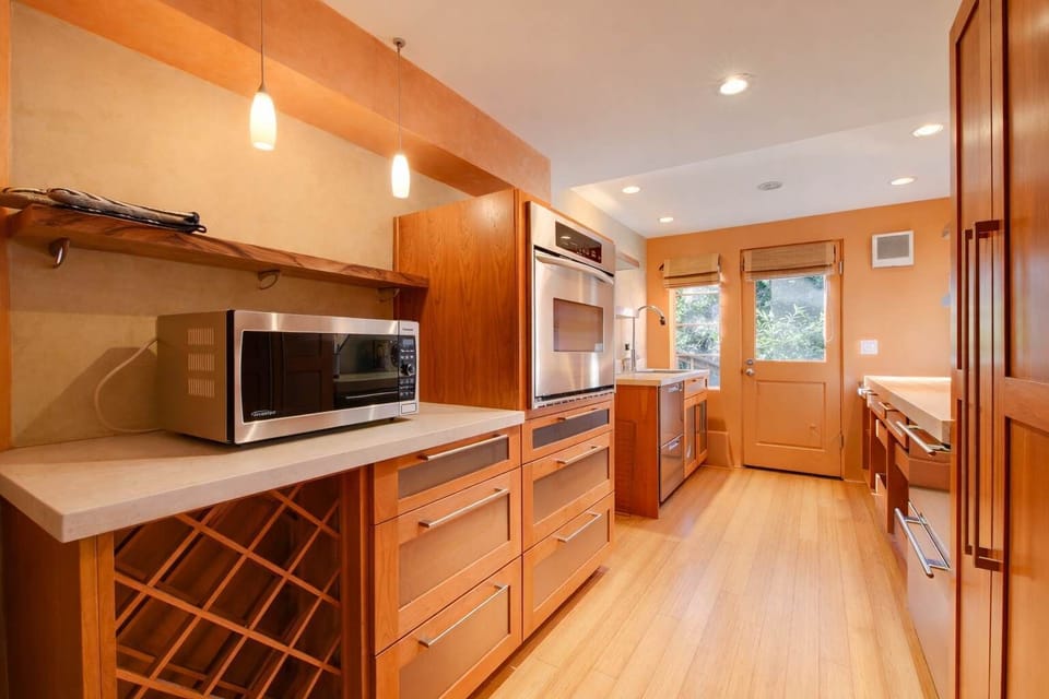 Warm and inviting kitchen with beautiful wood cabinetry, modern appliances, and a cozy layout perfect for preparing meals.