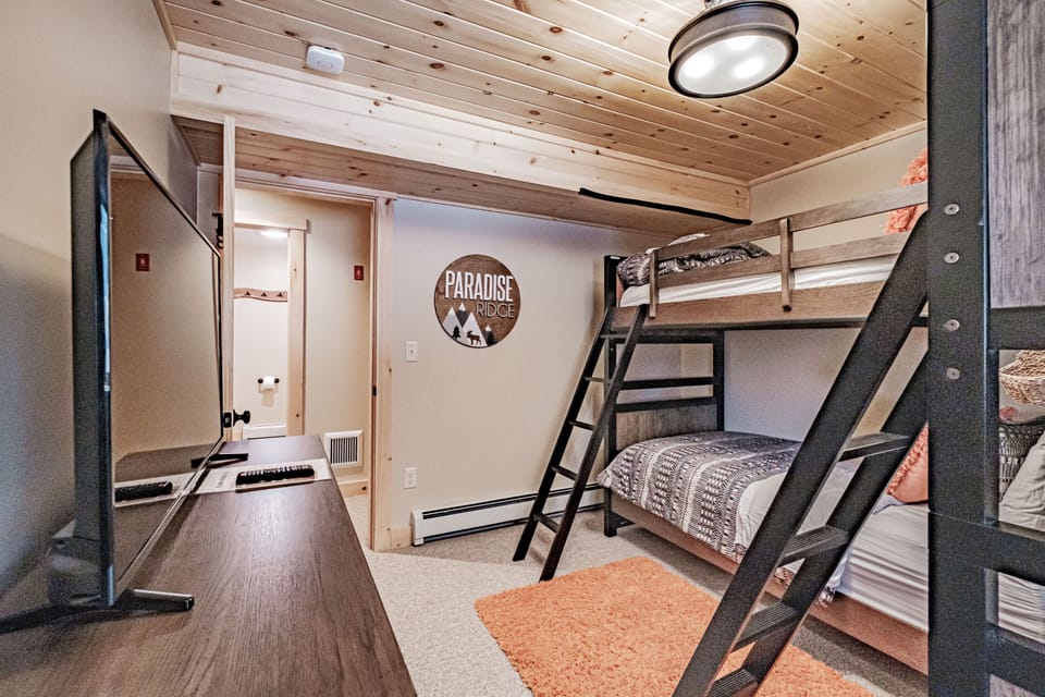 Bunk room has cable & internet-ready television, with bathroom across the hall 