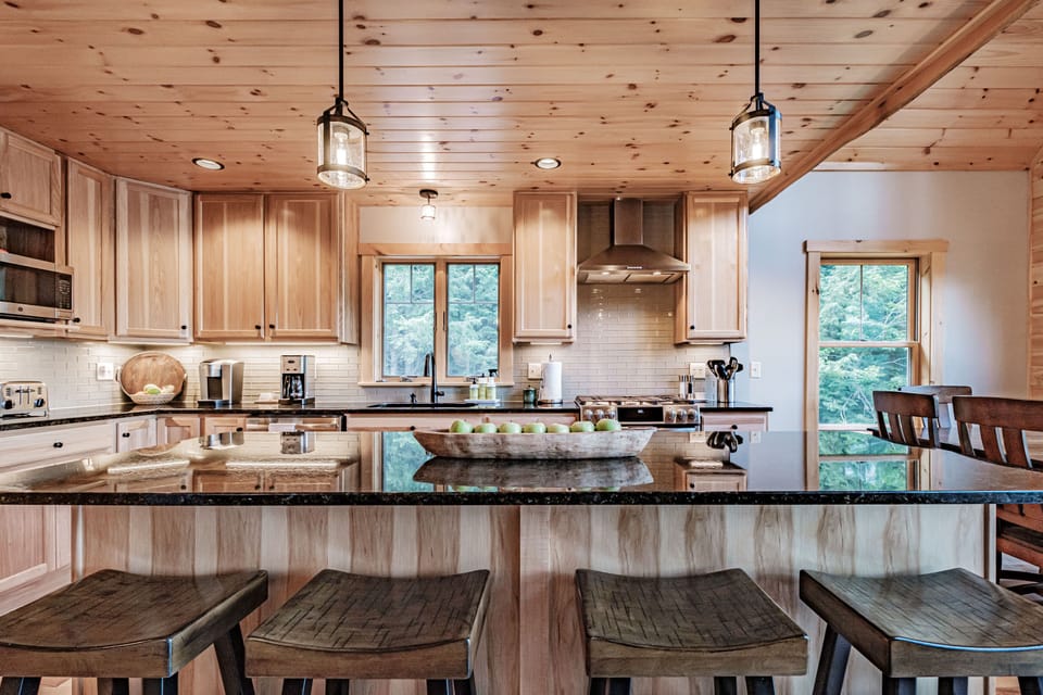 Fully-equipped modern kitchen. Gas range with vented hood