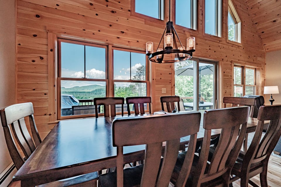 Dining table seats 8. Guests can enjoy a view of the mountains while dining.