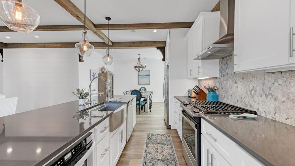The kitchen features modern finishes and a gas range!