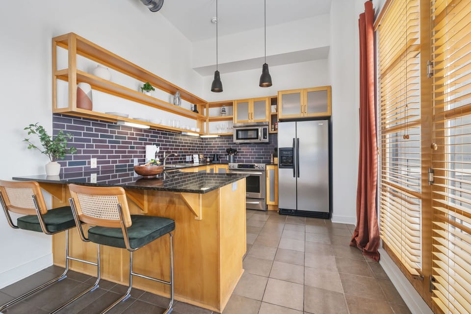 Modern kitchen with stainless steel appliances and a spacious breakfast bar.
