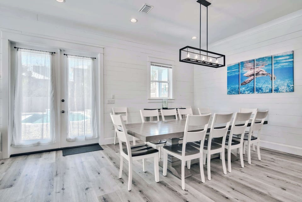 Airy dining area w/ a long table, ideal for shared meals & easy conversation.