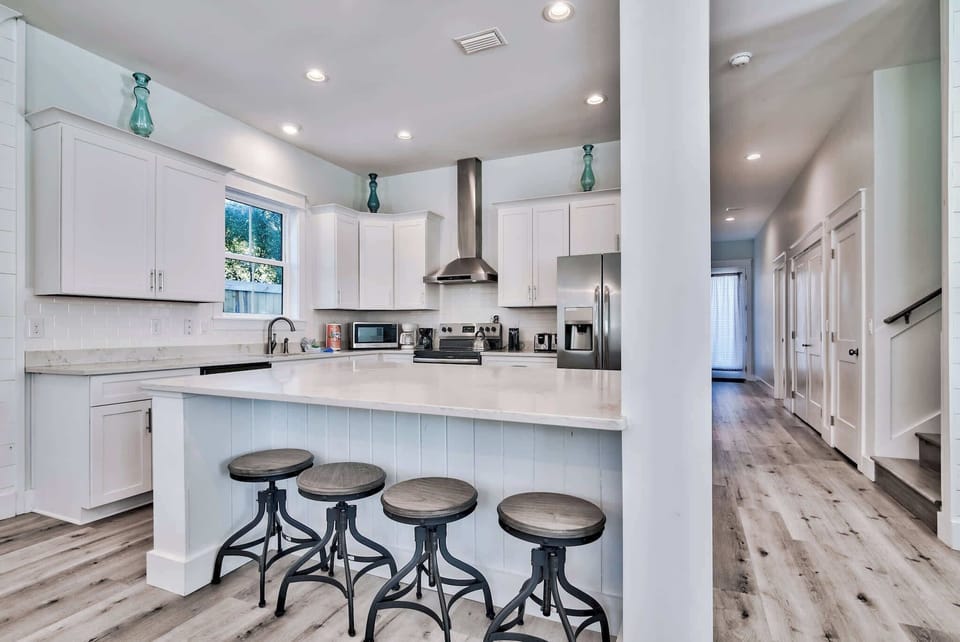 Modern kitchen island w/ bar stools for coffee, snacks, or chats.