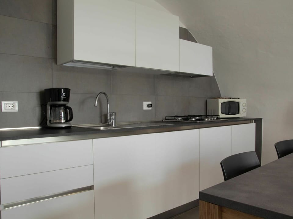 Tap, Cabinetry, Kitchen Sink, Countertop, Furniture, Sink, Kitchen Stove, Plumbing Fixture, Kitchen, Table