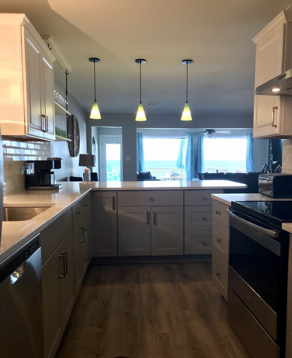 Gorgeous main kitchen fully stocked, beach views, open to living area.