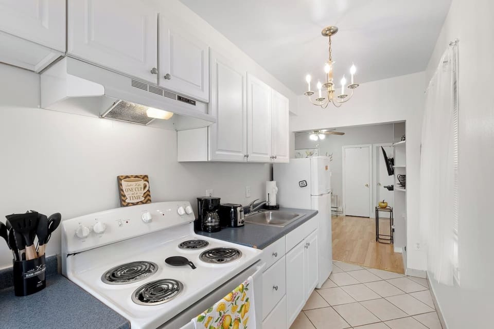 Stylish kitchen with a sleek design, complete with cookware and utensils for your convenience.