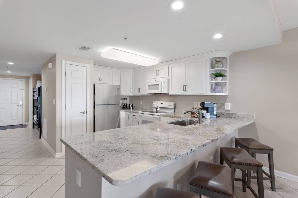 Kitchen with plenty of counter space, overlooking Dining Area & Family Room ~ Great for Entertaining!