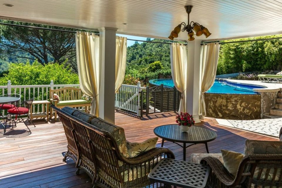 Covered outdoor living area looking toward the infinity edge pool