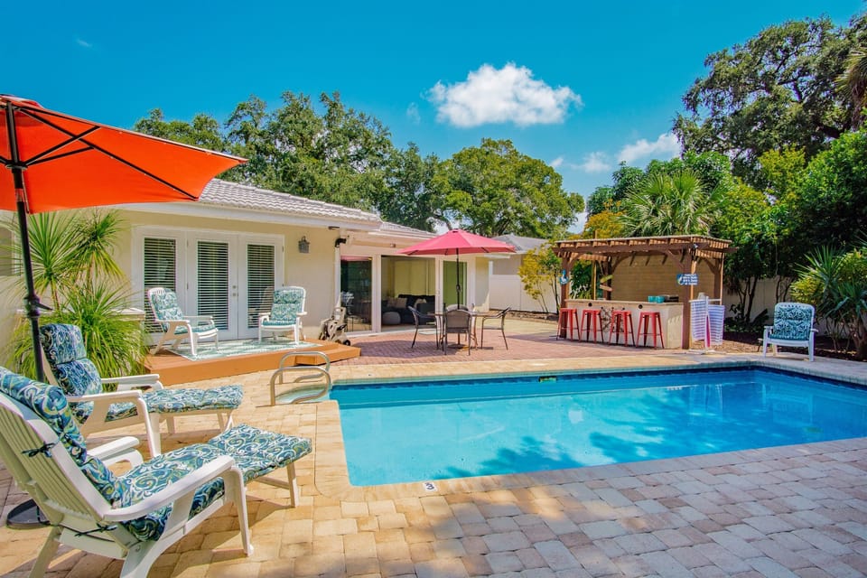 Private backyard paradise with SaltWater/heated pool, bar and grill.