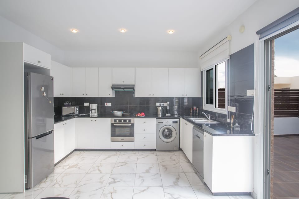 Modern kitchen fully equipped with all dishes and utensils needed