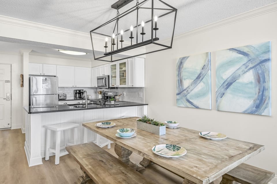 Gather around your beautifully appointed dining table, where coastal charm meets modern comfort in this open-concept space perfect for memorable meals.