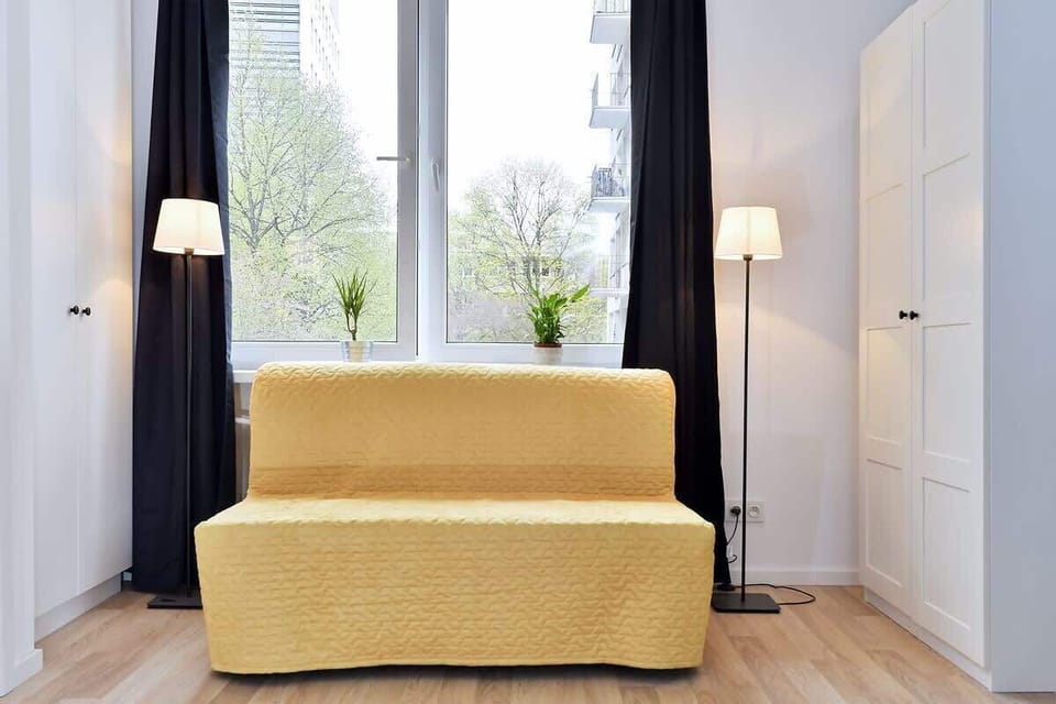 Living room with a comfortable fold-out sofa and wardrobe.