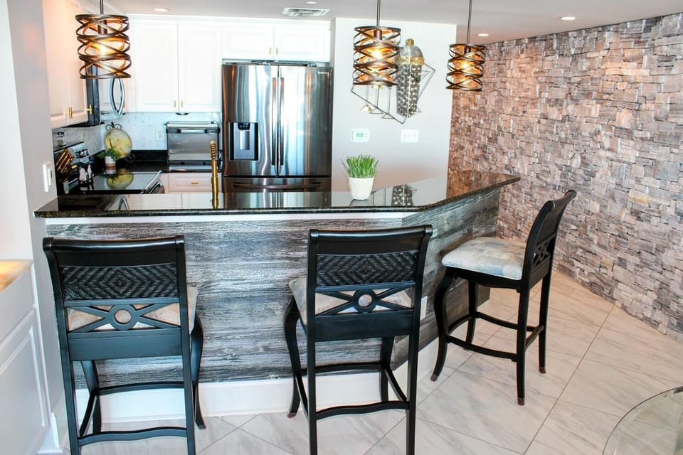 Modern kitchen with sleek appliances and cozy breakfast bar seating