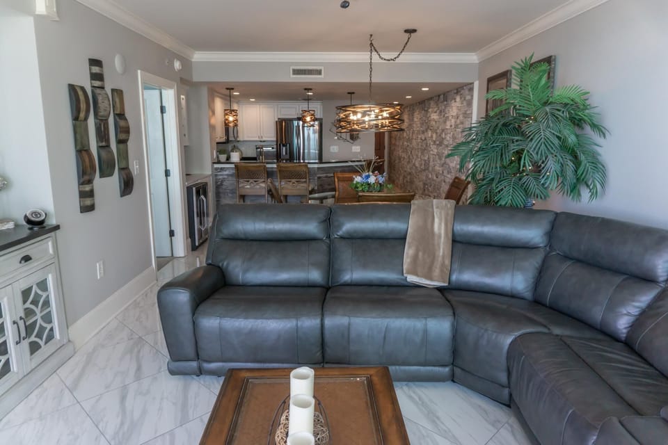 Spacious living room with plush leather seating and open layout