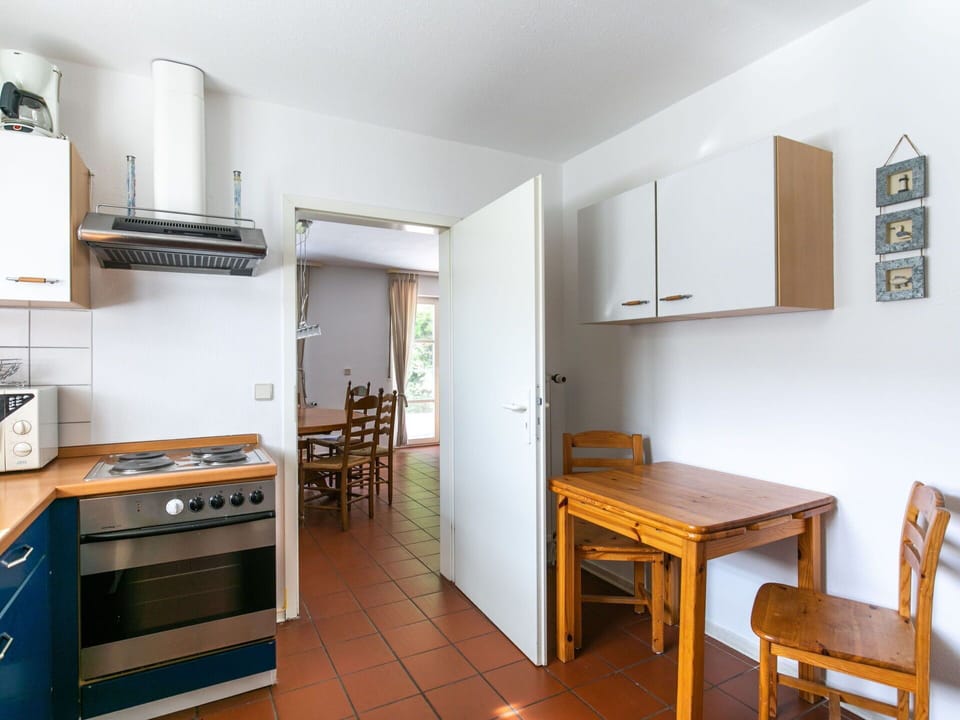 Furniture, Property, Table, Cabinetry, Wood, Kitchen Stove, Kitchen Appliance, Chair, Gas Stove, Flooring