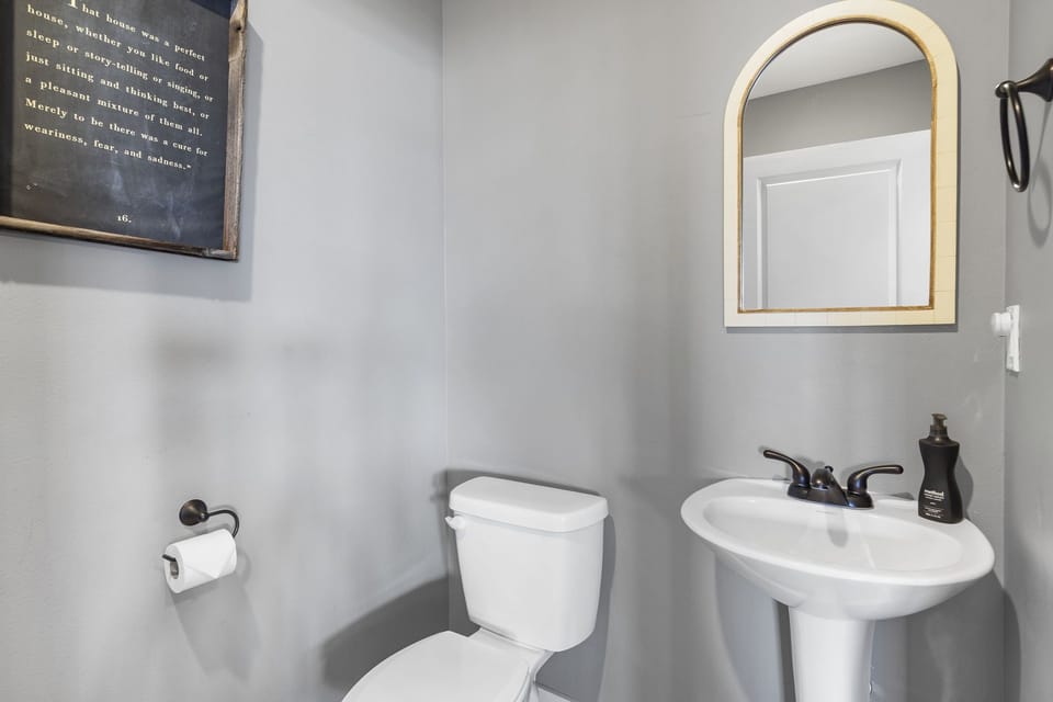 1/2 bathroom with washer and dryer located near living room