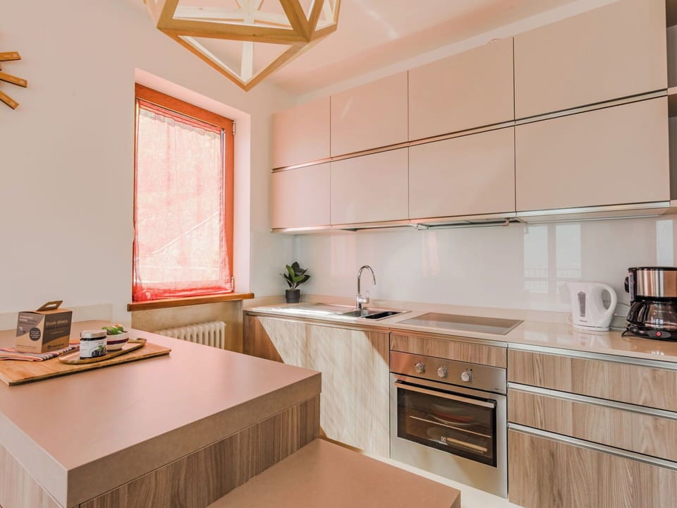 Kitchen, Countertop, Kitchen Appliance, Interior Design, Cabinetry, Flooring, Wood, Furniture, Major Appliance, Light Fixture