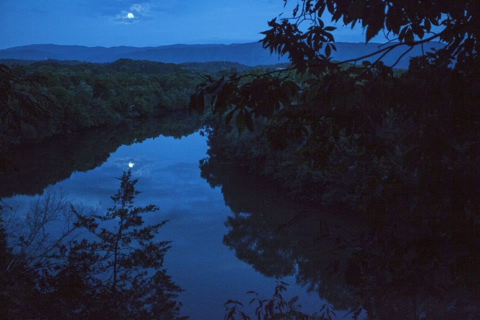 View of the Nolichuckey River from the front porch of the Log Cabin.
