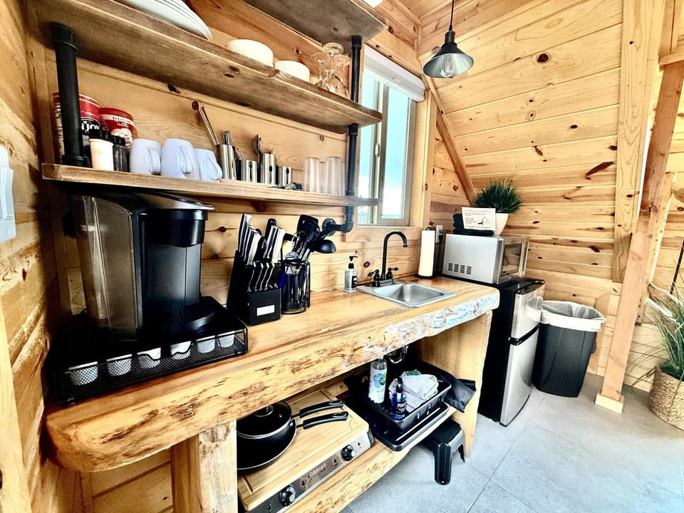 You have all that you need to prepare a meal with our kitchen and prep area with hot plate, fridge, microwave, Keurig Coffee Maker, and Kitchenware.