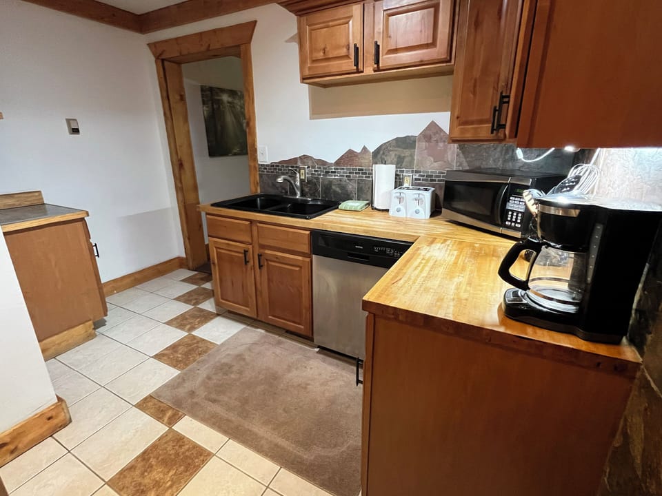 Kitchen with storage and stainless dishwasher