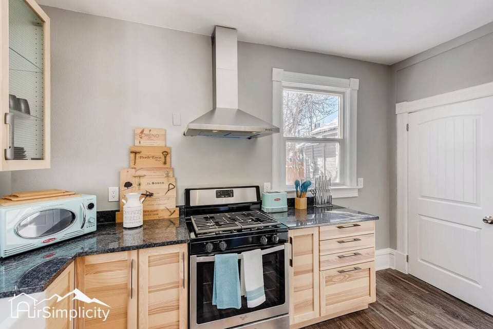 - Stainless steel gas stove with modern vent hood is ready for home cooked meals and baking
- Decorative cutting boards and mint kitchen accessories provide a cheerful pop
- Drawers and cabinets offer ample storage for all your cooking needs