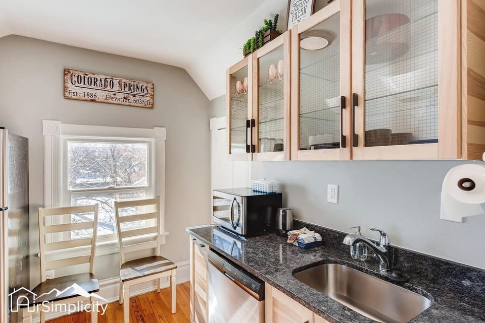 - Compact kitchen corner with sink, dishwasher, microwave, and glass cabinet storage
- Black granite countertops and wood accents offer a sleek cozy design
- Window seating for two invites you to sip coffee and watch the morning light