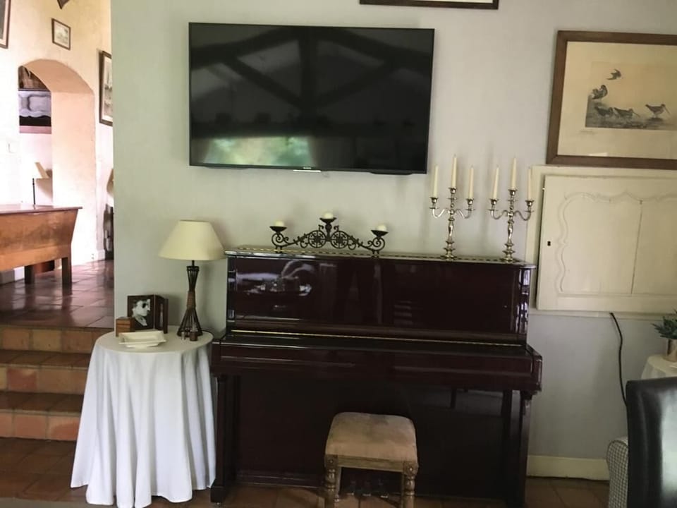 Secondary Living Room with piano and flatscreen Sony TV. 