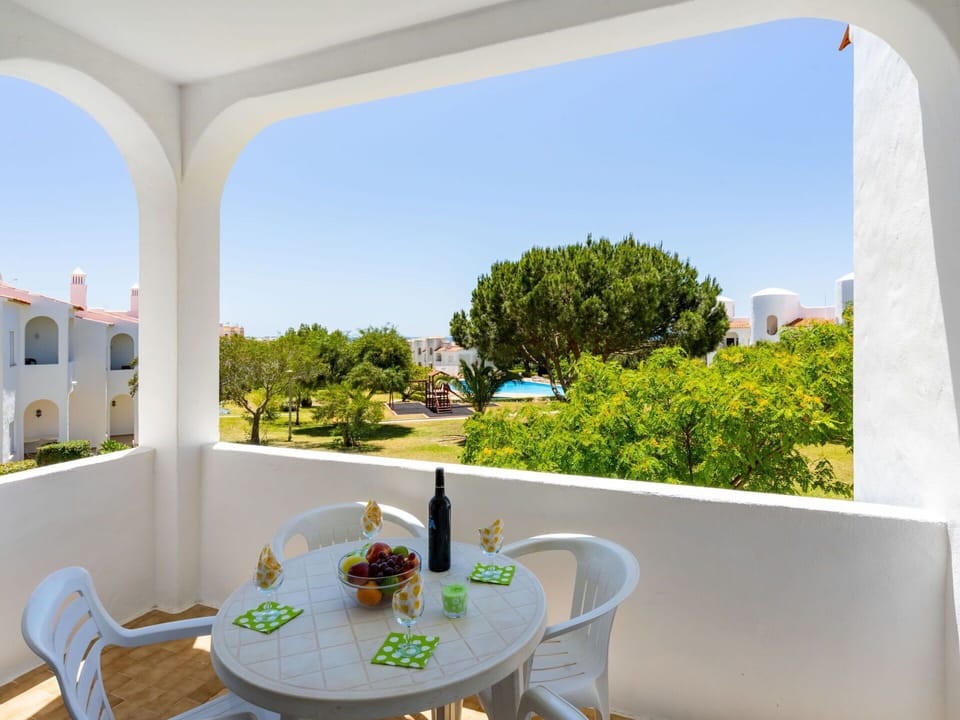 Table, Furniture, Property, Sky, Chair, Green, Azure, Building, Shade, Outdoor Furniture