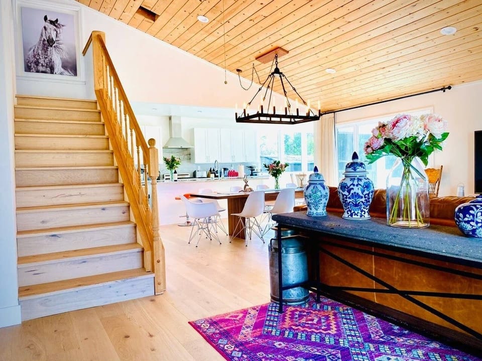 View at entry foyer looking into Great Room open dining area and stair to loft