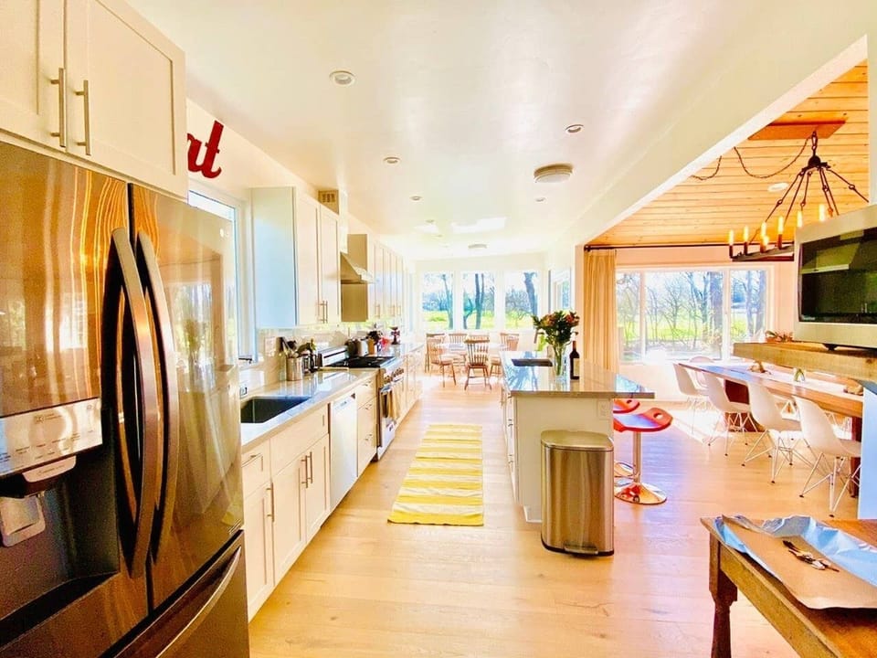 Coffee station next to kitchen open to dining and great room w garden views