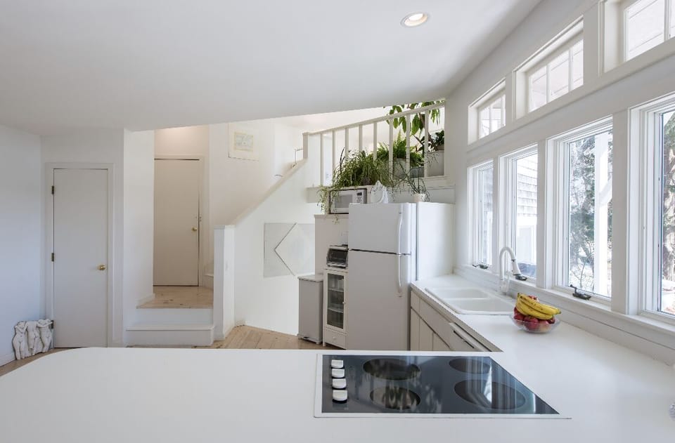 Open kitchen for entertaining and celebrating. Stairs to loft and lower bedroom