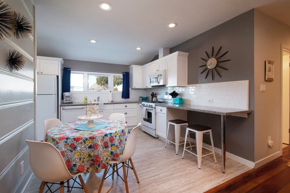 Kitchen within dining table for 4 with additional counter top bar height seating
