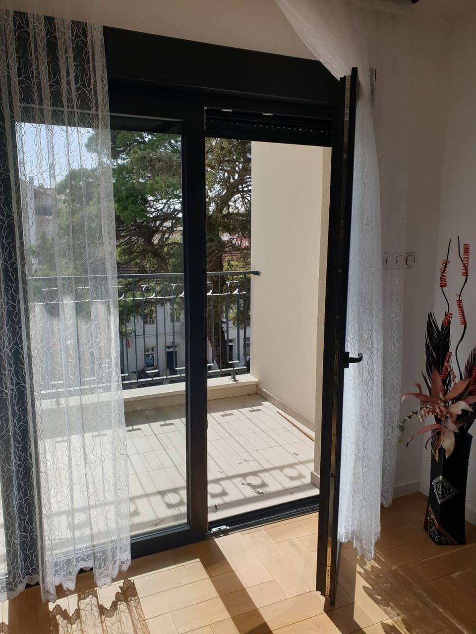 The living room opens to a furnished balcony ...