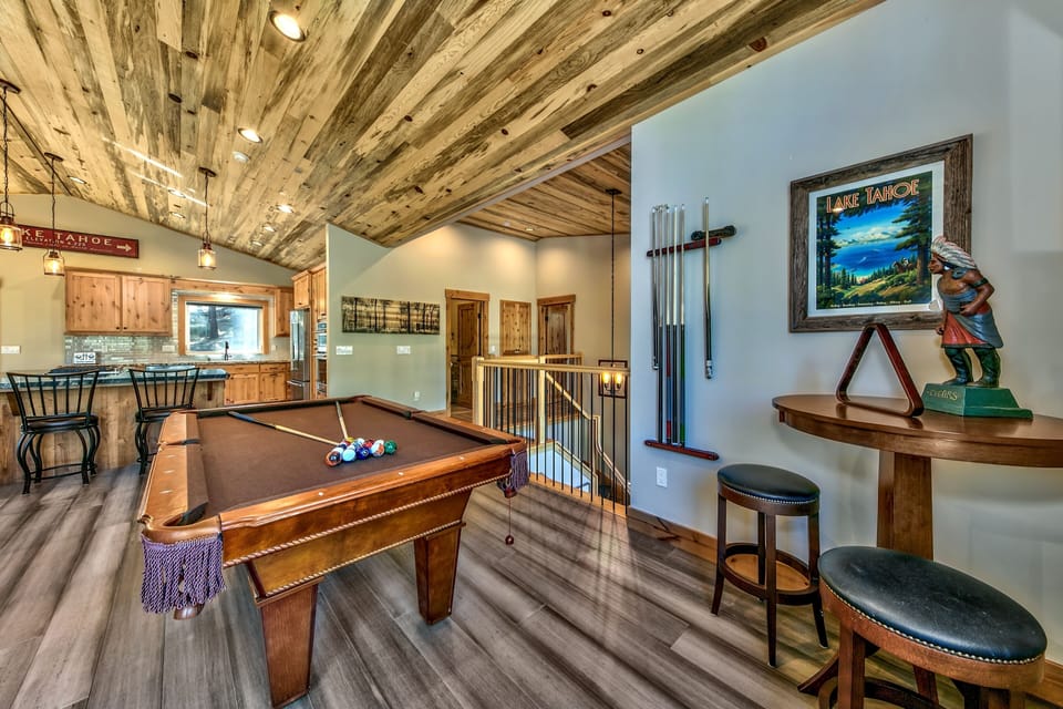 Watch the pool game or wait for your turn at this hi-top table with two stools