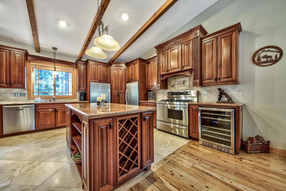 Step into your gourmet kitchen with rich wood cabinetry, granite counters, and professional stainless appliances - perfect for creating memorable meals.