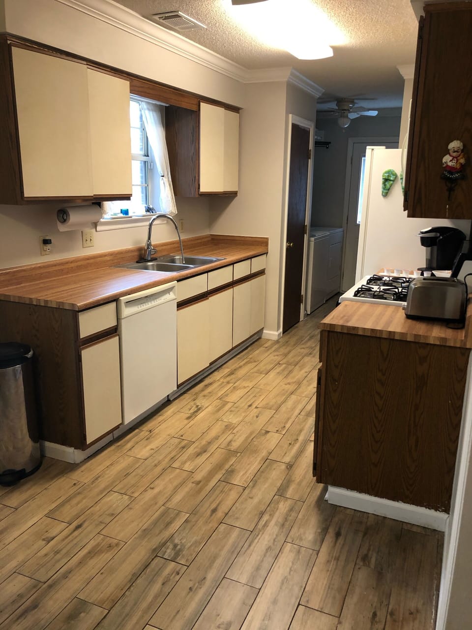Full Kitchen - Sink overlooks back yard. Kitchen table behind person taking pic.