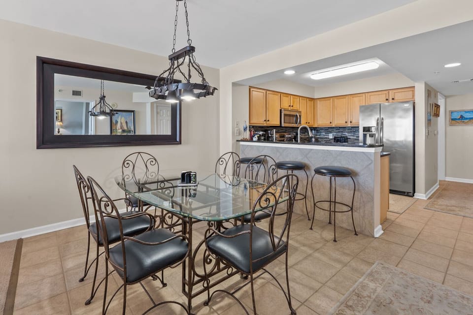 Dining table and bar stools beneath a chandelier at South Shore Villas Penthouse 2, Crescent Beach, North Myrtle Beach