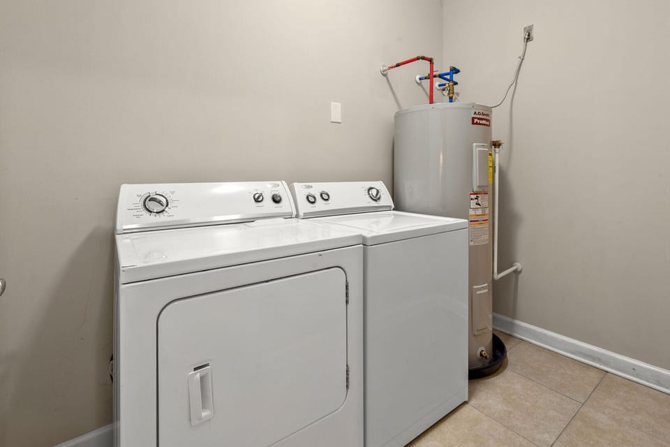 Washer, dryer and water heater in the laundry room at Palmetto Coast, Villa B, Crescent Beach