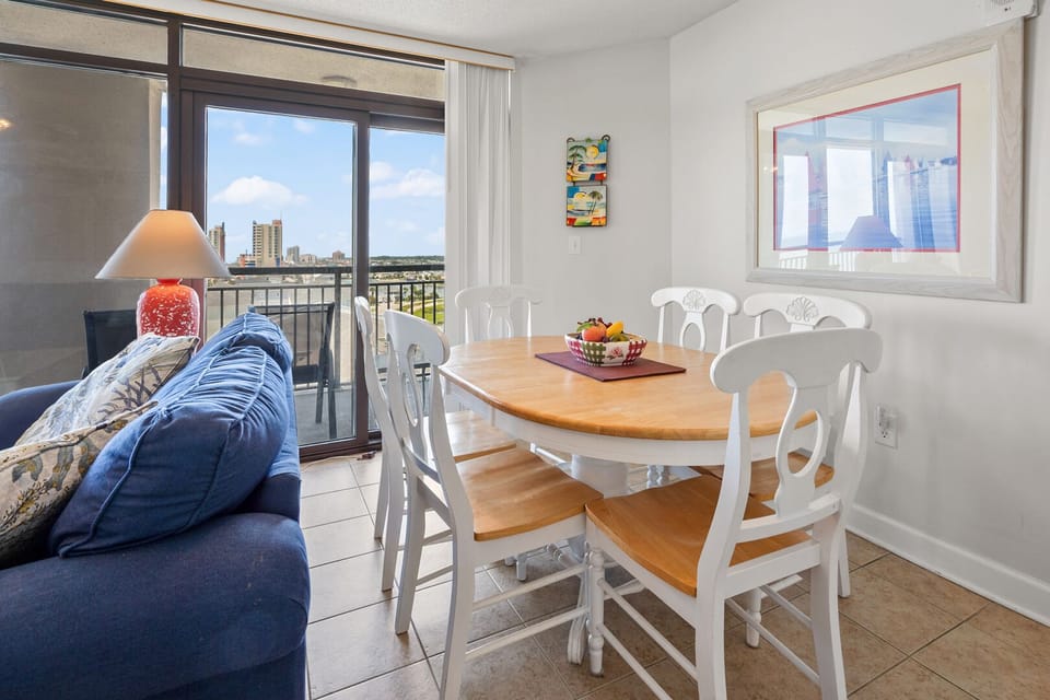 Dining table beside the sliding doors and ocean view at Beachwalk Villas 401 in Cherry Grove