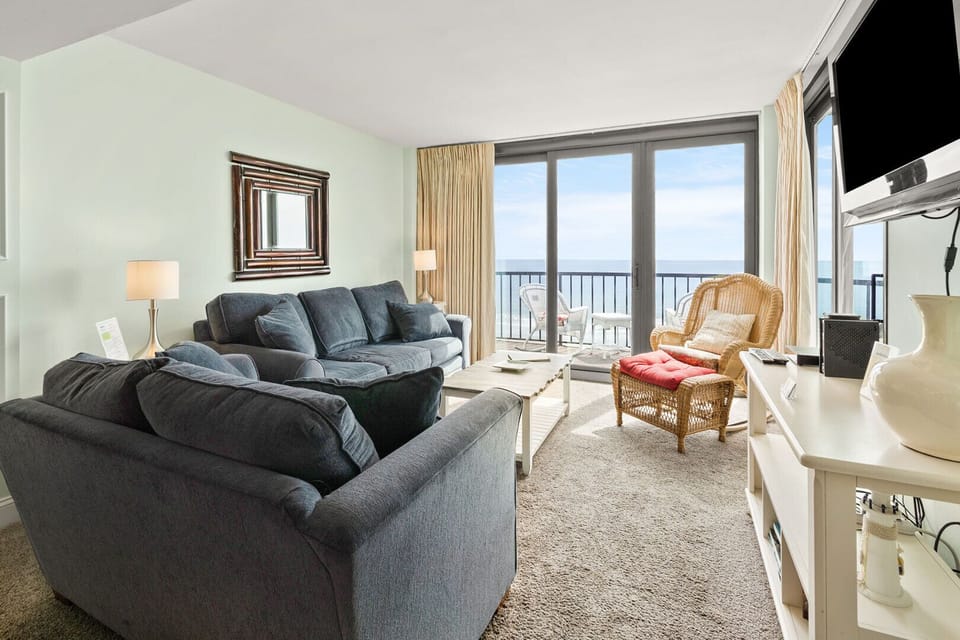 Sectional sofa and sliding doors to the balcony at Crescent Sands of Crescent Beach I6 in North Myrtle Beach