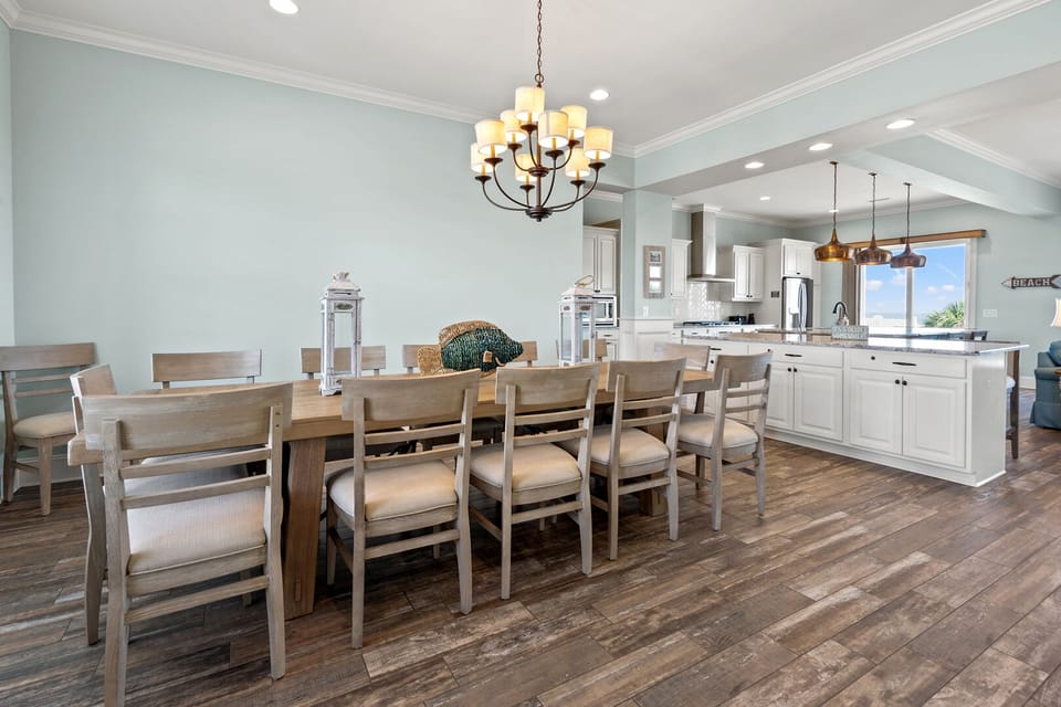 Dining table for six under a chandelier at Beach House, a 7-bedroom Tilghman Beach vacation rental
